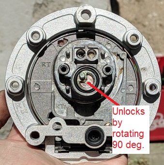 Gas unlock mechanism. 90 deg rotation pulls the lock pin back.